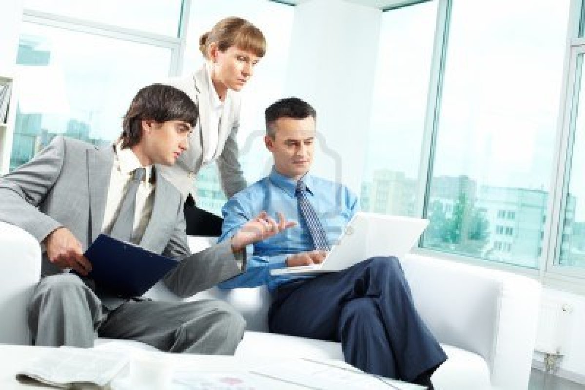 9819298-a-business-team-of-three-sitting-in-office-and-planning-work.jpg